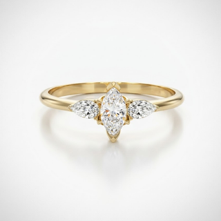 Gold ring with marquise-shaped diamond on a light gray background, lab grown diamond in hyderabad