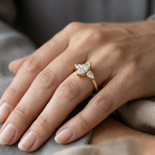 Close-up of a hand wearing a diamond ring on a neutral background, lab grown diamond in hyderabad