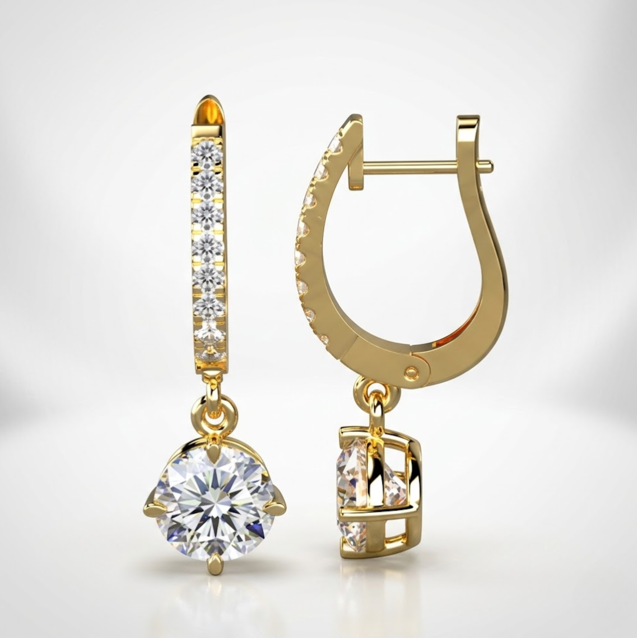 Gold earrings with clear gemstones on a light gray background, lab grown diamond in Hyderabad