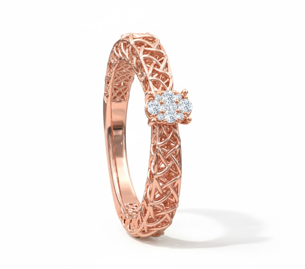Rose gold ring with intricate design and small diamonds on a white background