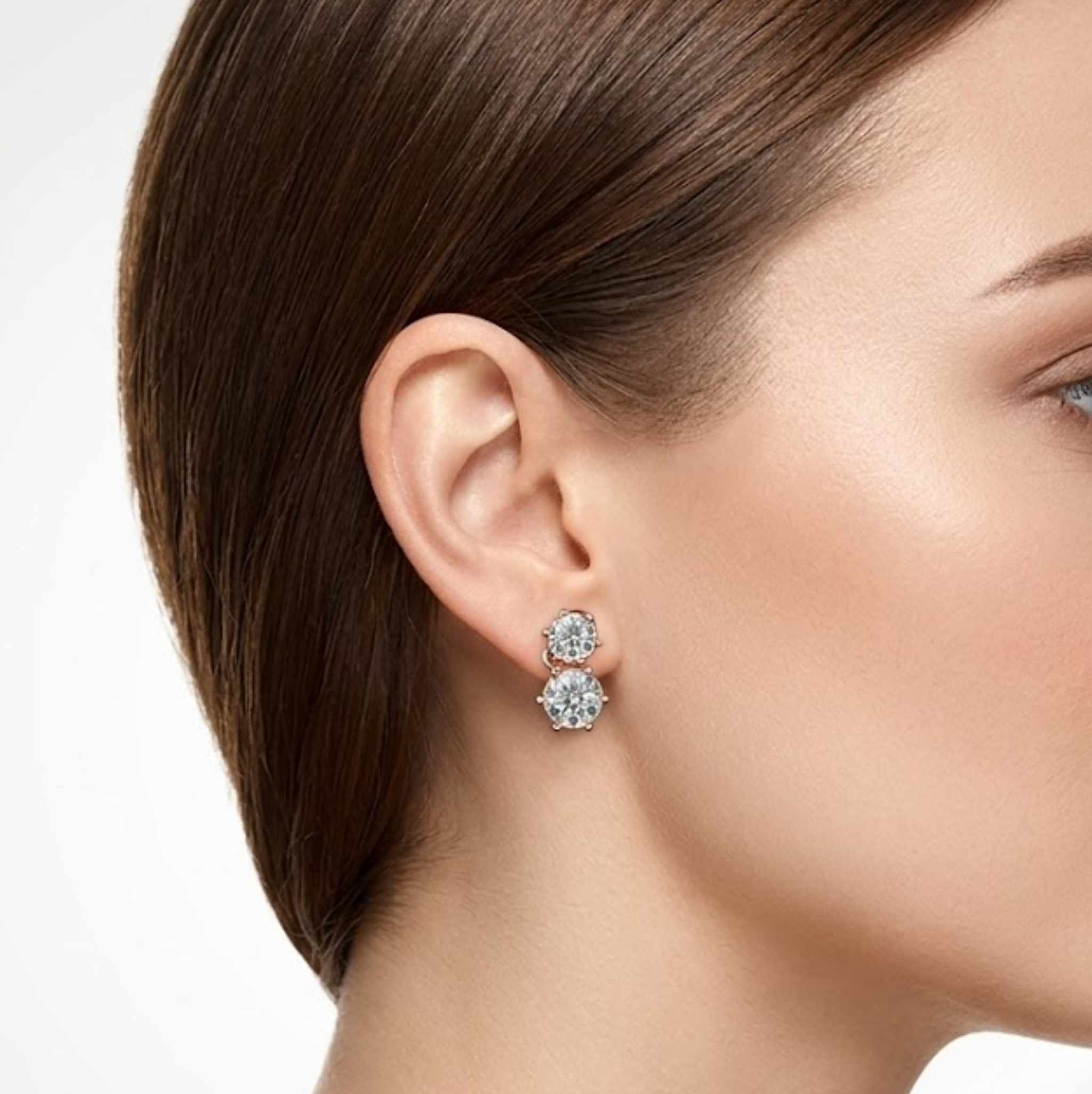 Close-up of a woman wearing a pair of earrings with a neutral background, lab grown diamond in Hyderabad