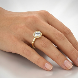 Gold ring with a diamond on a hand against a light background, lab grown diamond in hyderabad