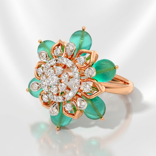 Rose gold ring with emerald green gemstones and diamonds on a light gray background, lab grown diamond in hyderabad