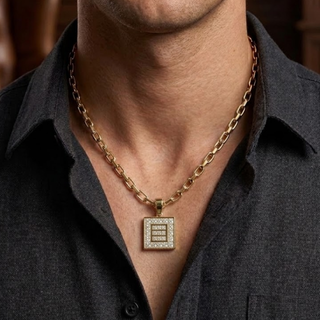 Gold necklace with a square pendant worn by a person in a dark shirt, lab grown diamond in hyderabad