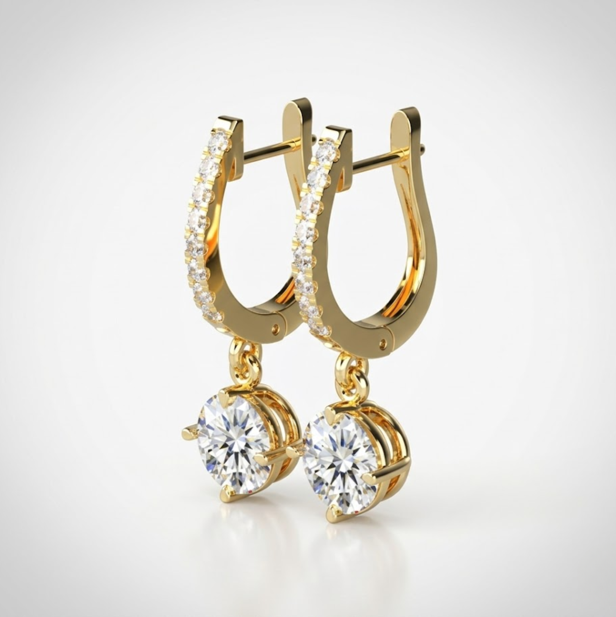 Gold hoop earrings with round gemstones on a light gray background, lab grown diamond in Hyderabad