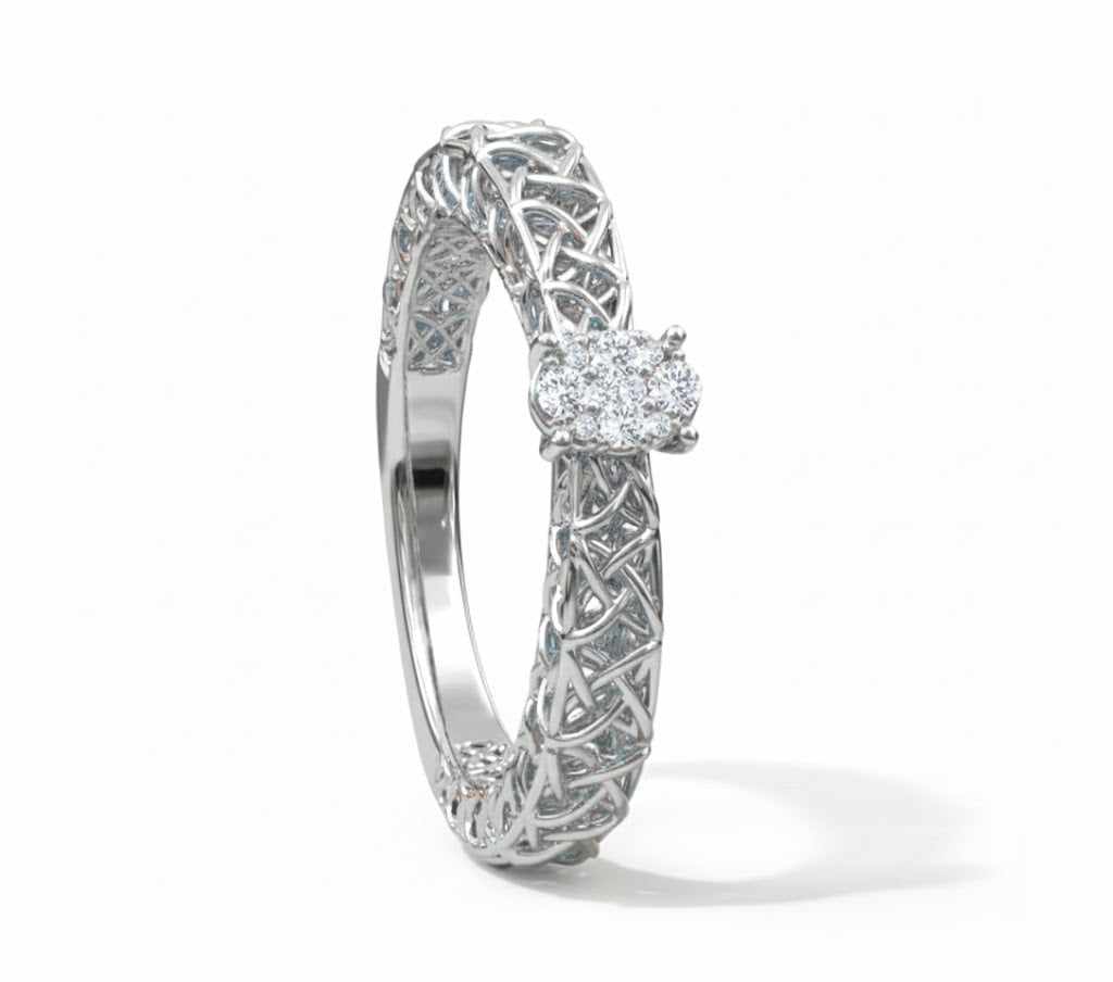 Silver ring with intricate design and a diamond on a white background